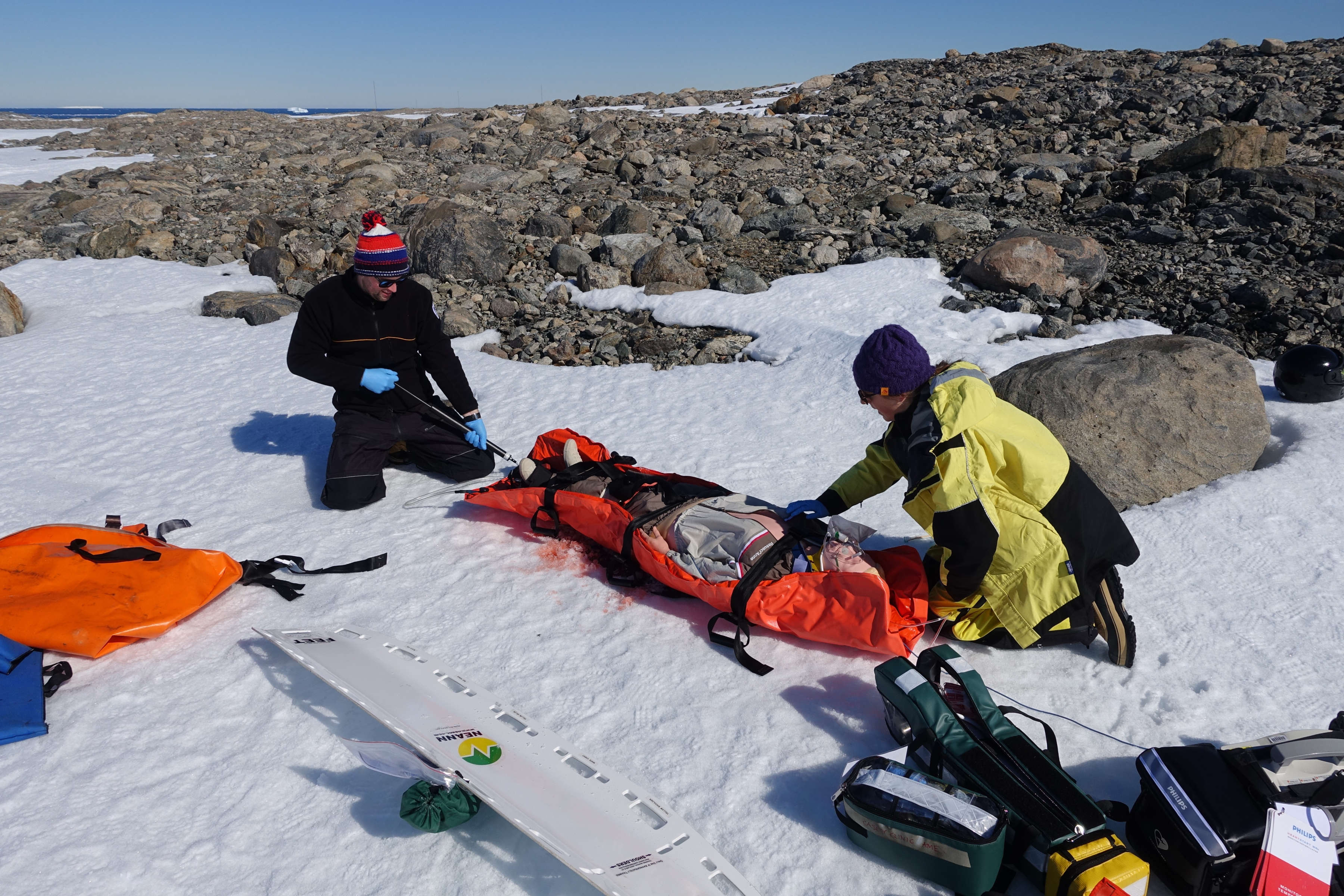 Two medical practitioners responsing to mock emergency with dummy patient on a stretcher. Photo: Grant Jasiunas.